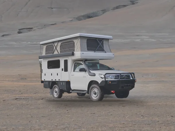 SUNHOMEE tray-mount camper on a Hilux cab-chassis in a high desert valley
