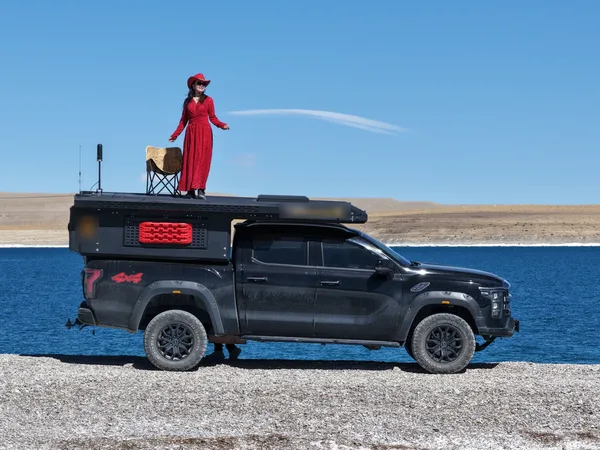 SUNHOMEE camper on a pickup beside a lake