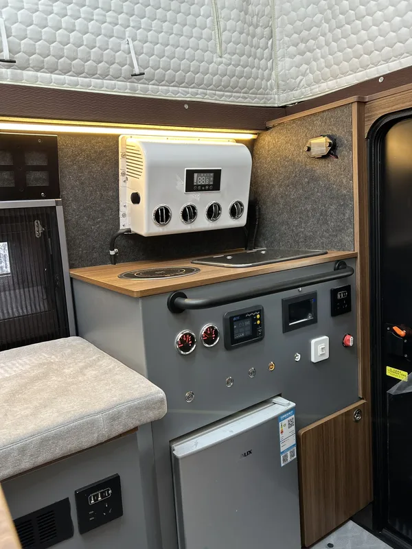 Camper kitchen unit with induction hob, controls and fridge