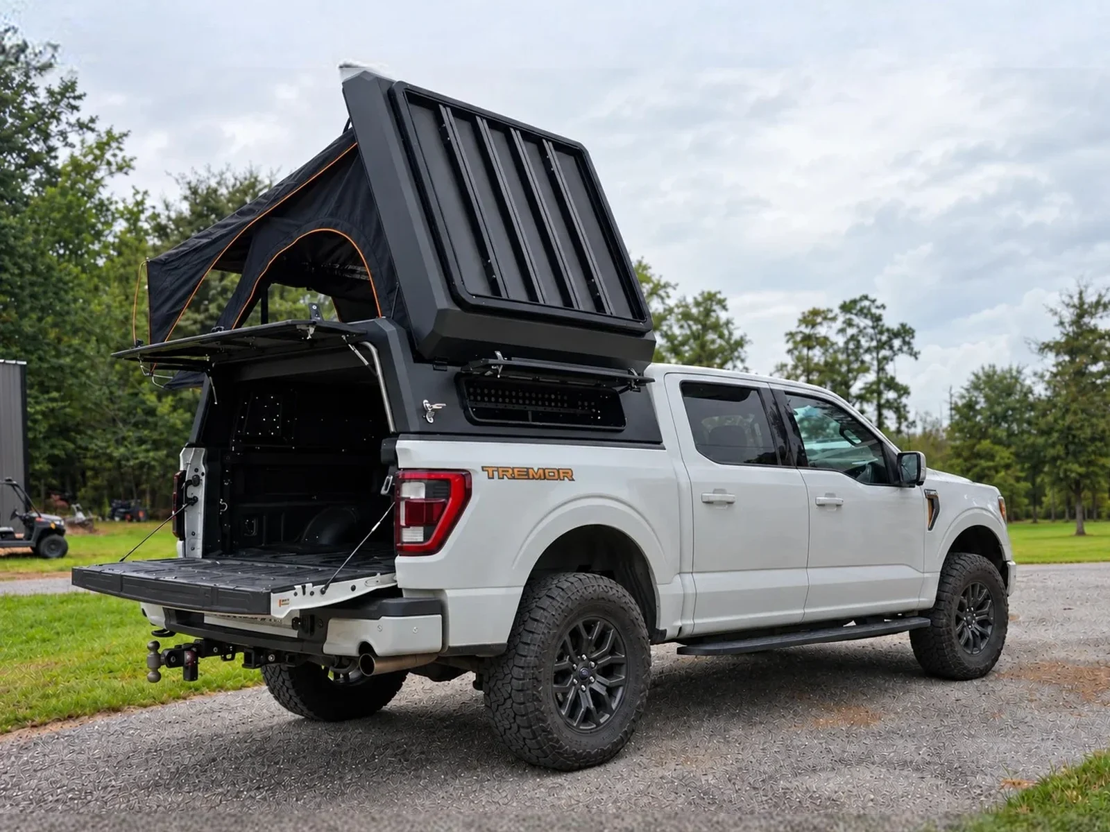 Stealth pop-up topper with the tent open on a white Ford F-150