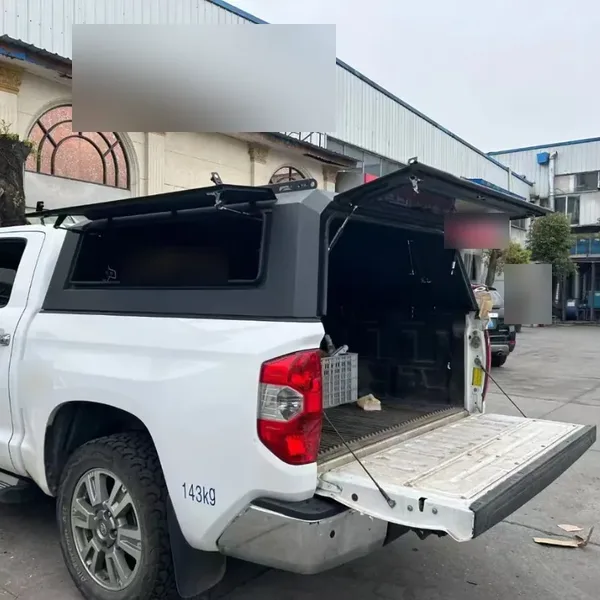 SUNHOMEE truck topper on a white Toyota Tundra with the rear door open