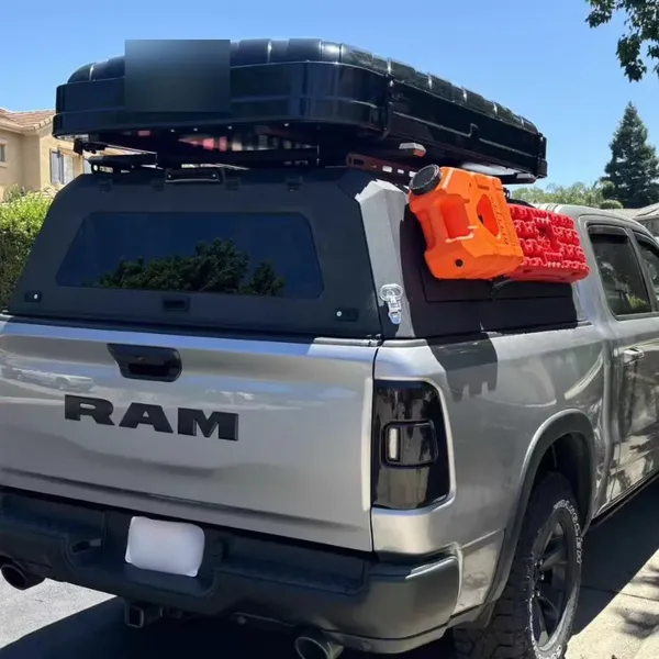 Rear view of a SUNHOMEE aluminum truck topper on a silver RAM pickup