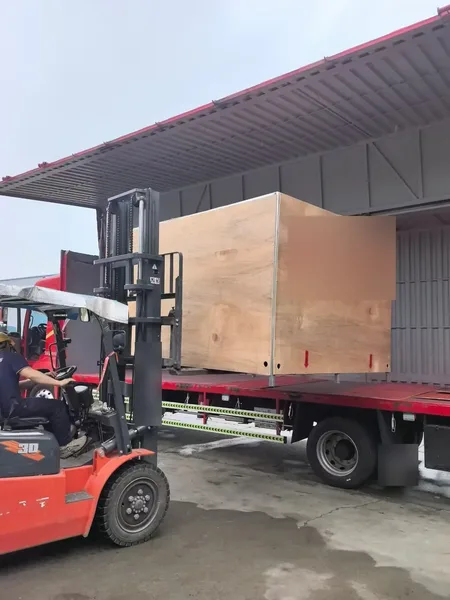 Export crate being loaded onto a ute by forklift