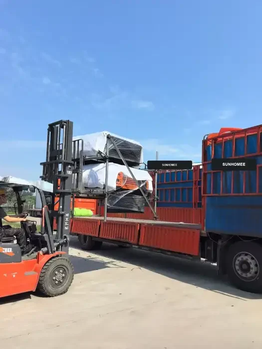 Crated units being loaded for export.